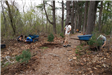 A volunteer looks down the trail at work in progress.